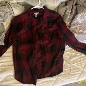 A plaid maroon and black button up shirt
